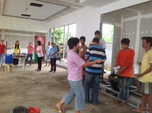Sister Nel Landig distributing tracts to the construction workers for TBC's new building